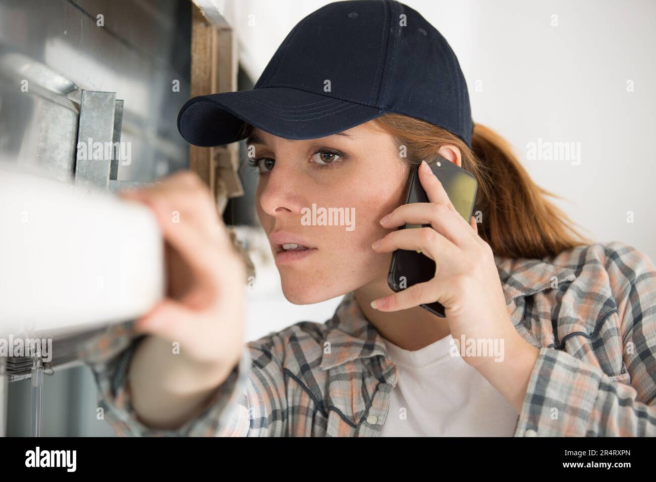Female contractor talking on mobile hi-res stock photography and images ...