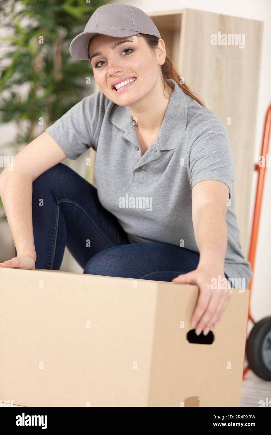 professional female mover doing home relocation Stock Photo