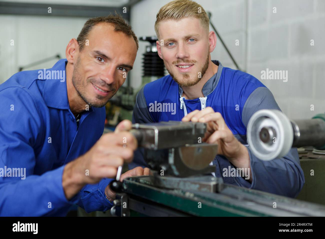 two machinists at work posing Stock Photo Alamy