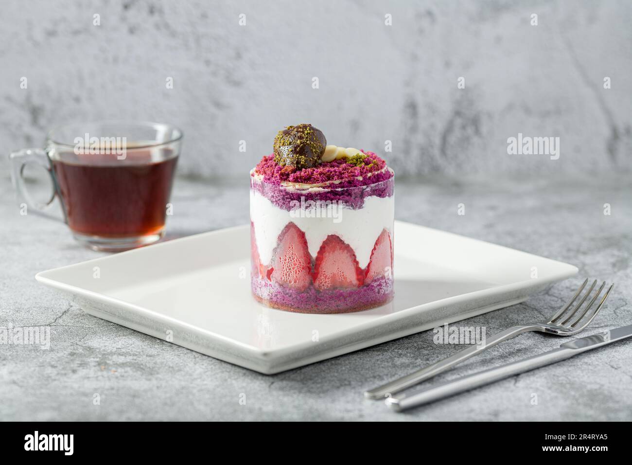 Strawberry shortcake with tea on a white porcelain plate Stock Photo