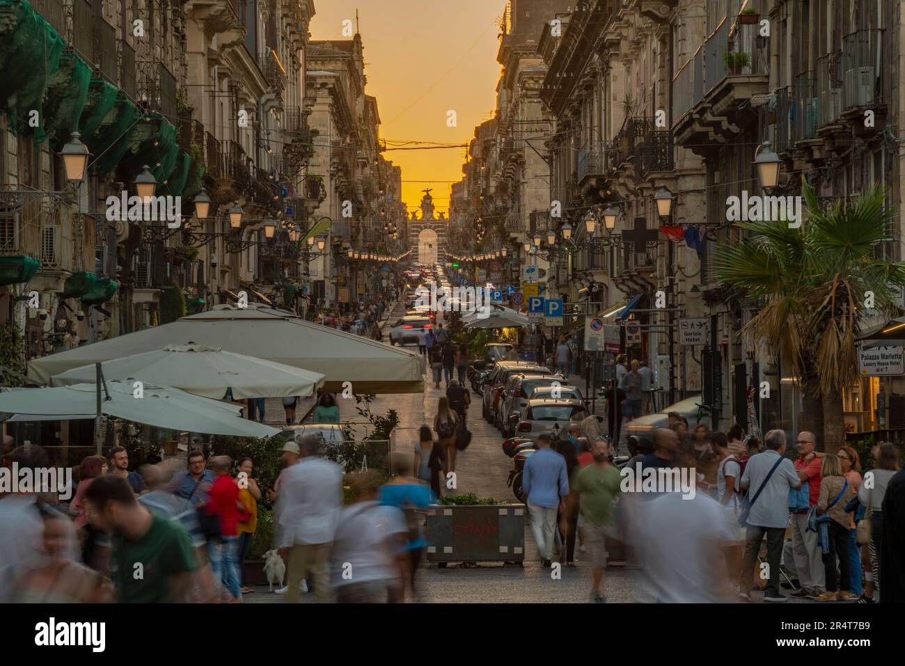 View of busy street leading to Porta Garibaldi at sunset, Catania, Sicily, Italy, Europe Stock Photo