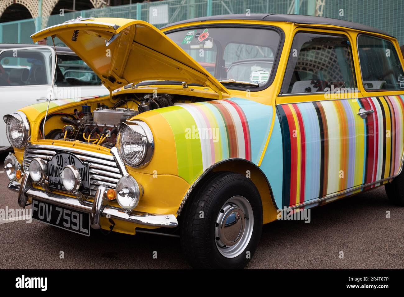 Brighton, UK - May 19 2019:  A beautiful painted striped Mini car is on display with an open bonnet at the London Brighton Mini Run 2019. Stock Photo