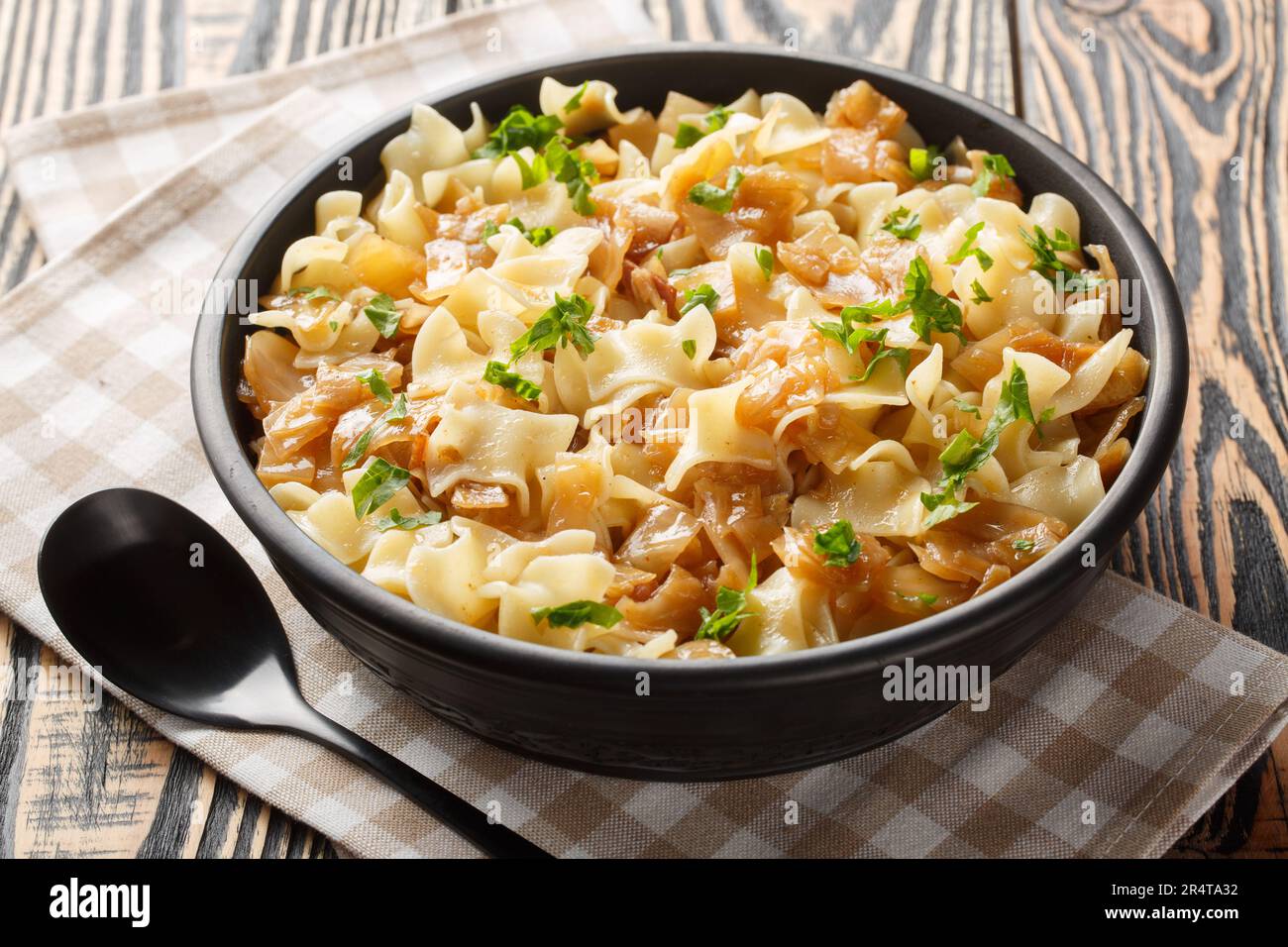 Noodles with stewed cabbage Austrian cuisine closeup on the bowl on the table. Horizontal Stock Photo