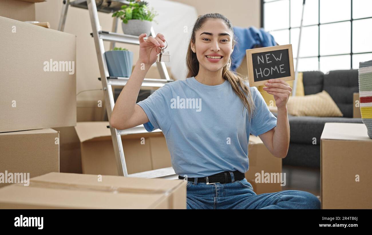 Young beautiful hispanic woman smiling confident holding new house keys ...