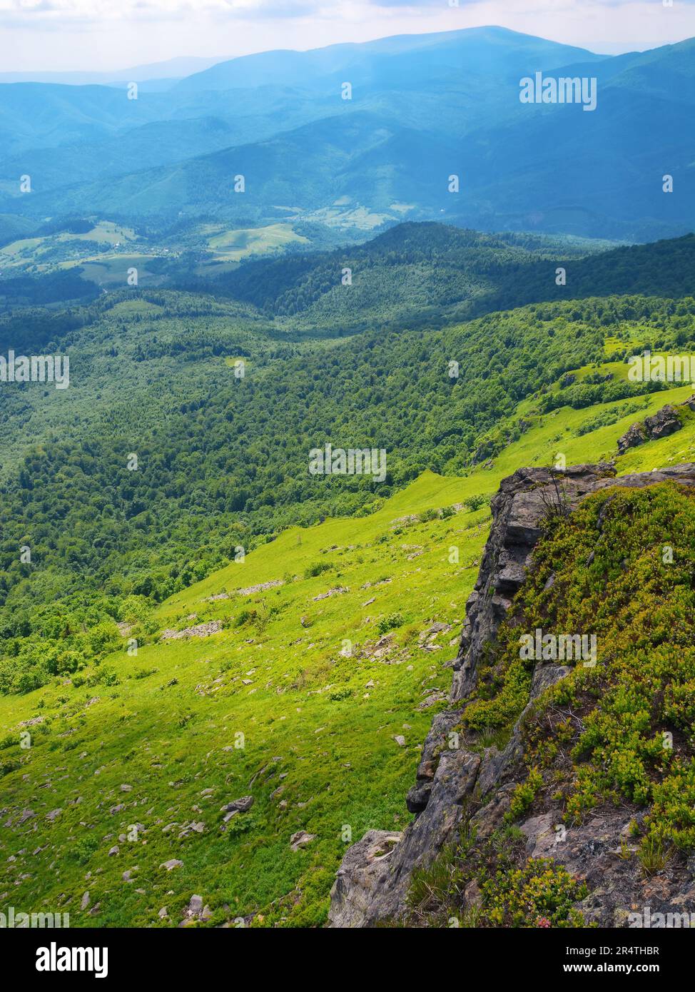 carpathian watershed ridge. stones and boulders on the green grassy hills. open view to distant mountain. hot summer day Stock Photo