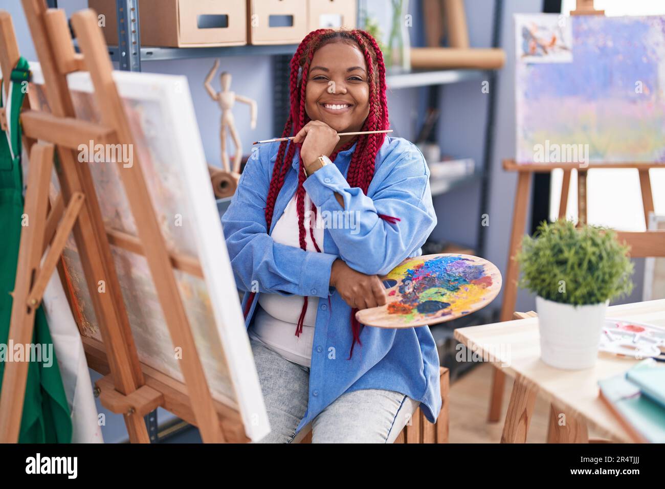 African american woman artist smiling confident drawing at art studio ...
