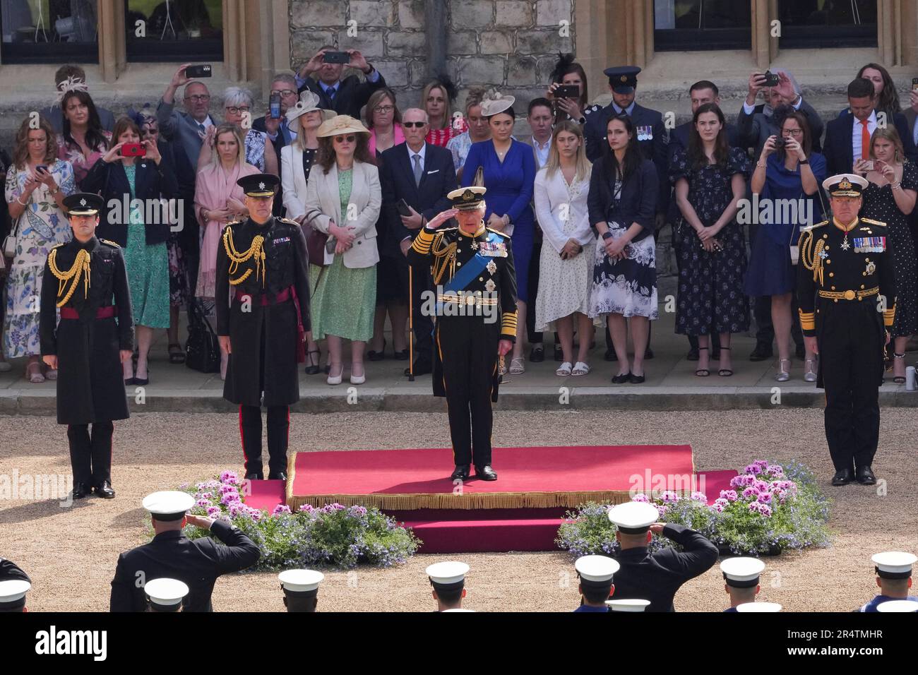 King Charles III receives the royal salute from Royal Navy personnel at