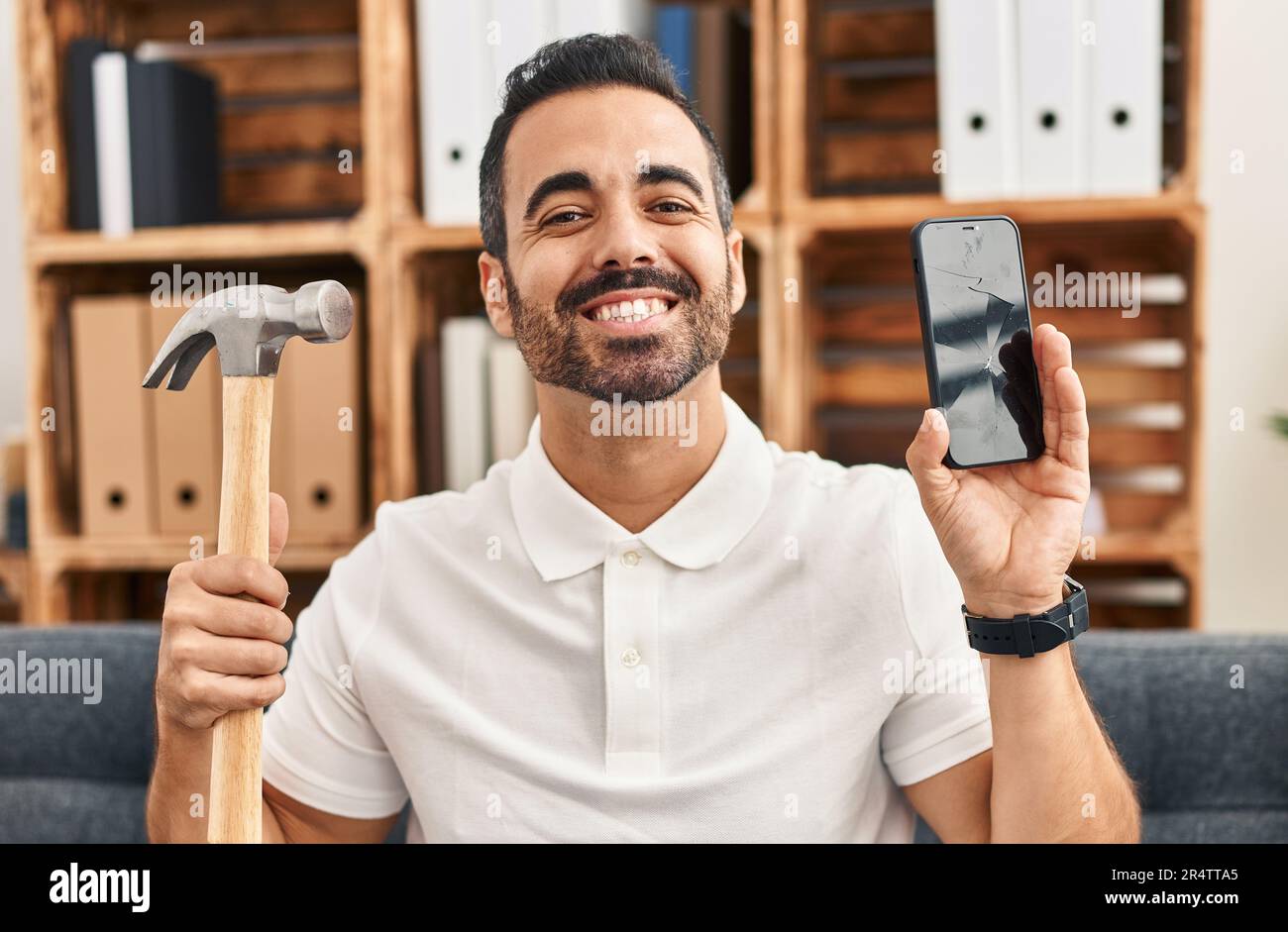 Young hispanic man with beard holding hammer and broken smartphone showing  cracked screen smiling with a happy and cool smile on face. showing teeth  Stock Photo - Alamy