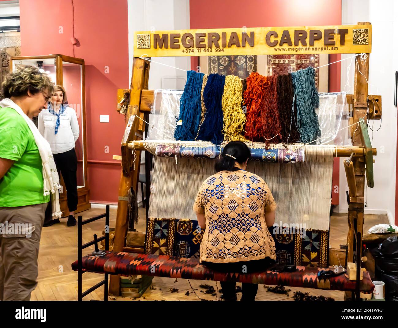 Megerian Carpet stand with a carpenter woman master performing carpet weaving. Yerevan Armenia