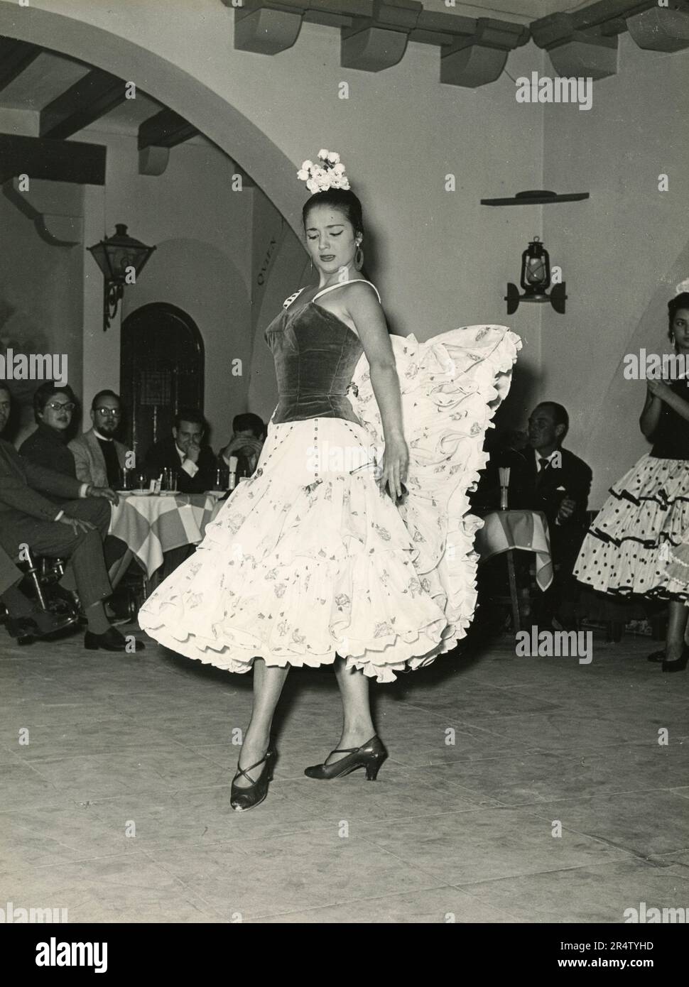 Young woman wearing traditional Spanish dress dancing Flamenco, Spain ...