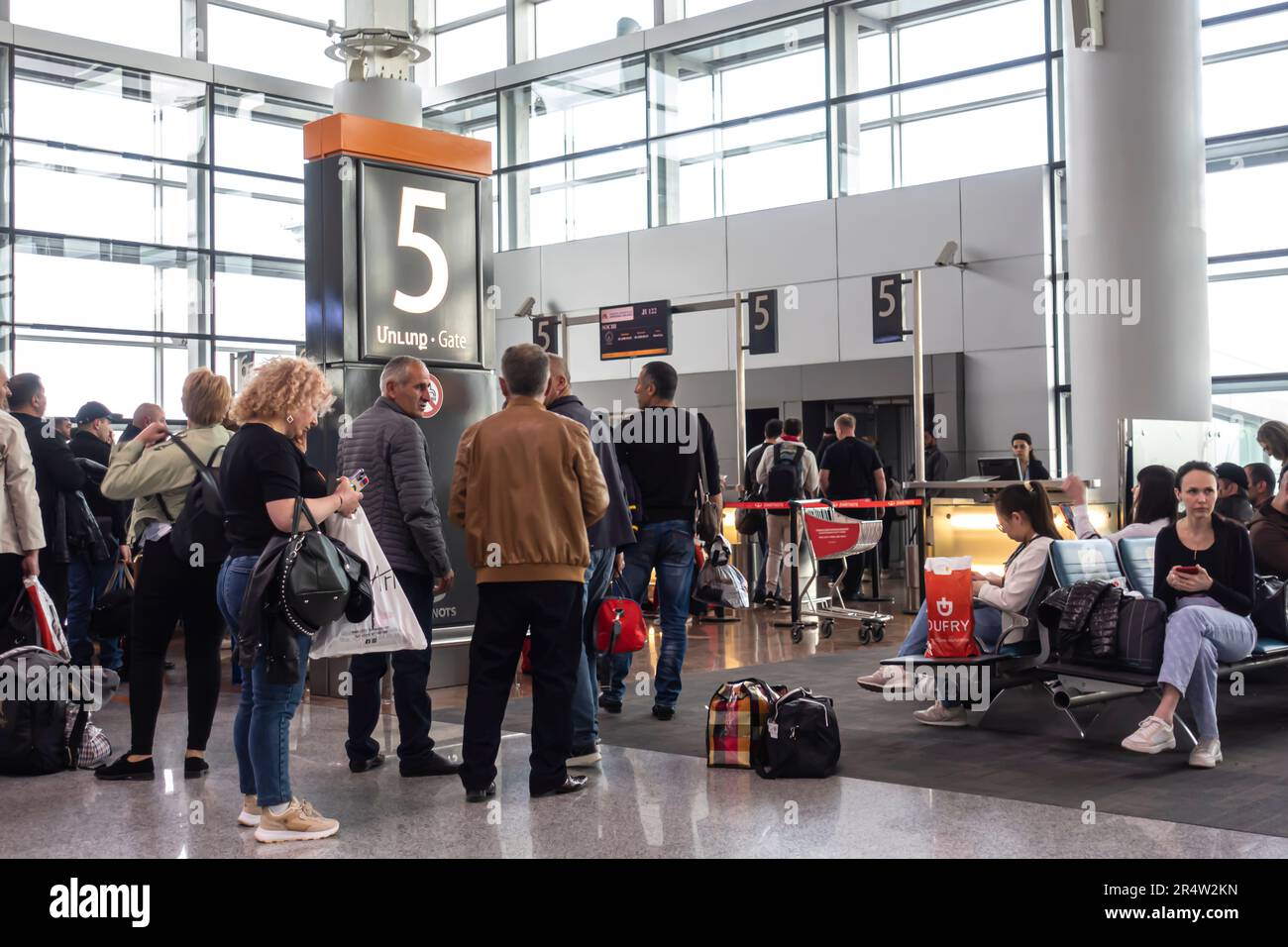 Passengers in line waiting to board at the Gate 5 airport terminal, Zvartnots International Airport in Yerevan, Armenia. Stock Photo