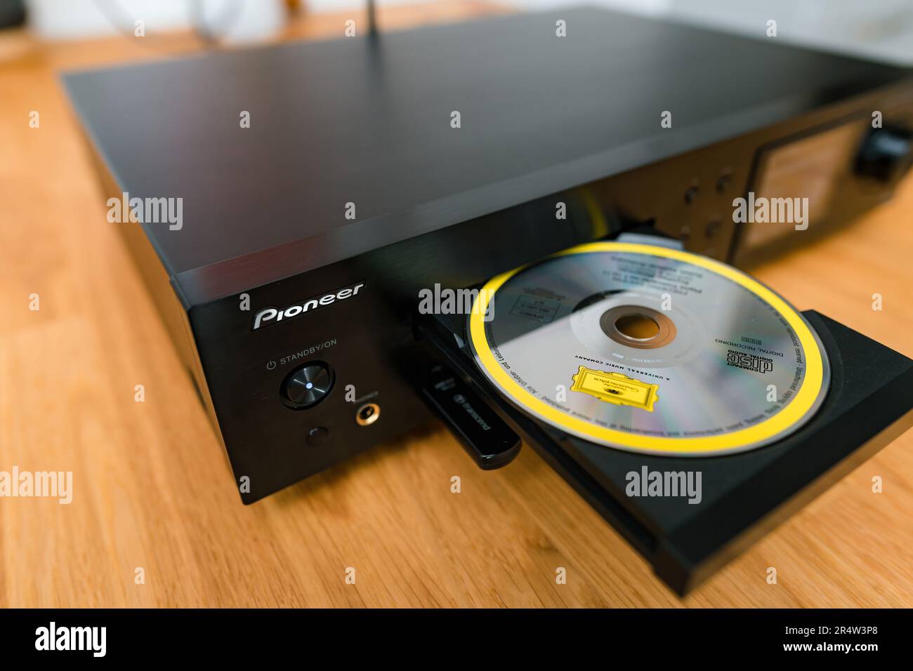 Frankfurt, Germany - Jan 30, 2023: A closeup of a modern Pioneer NC-50DAB stereo hi-fi system with an open CD tray, logotype and buttons on the wood t Stock Photo