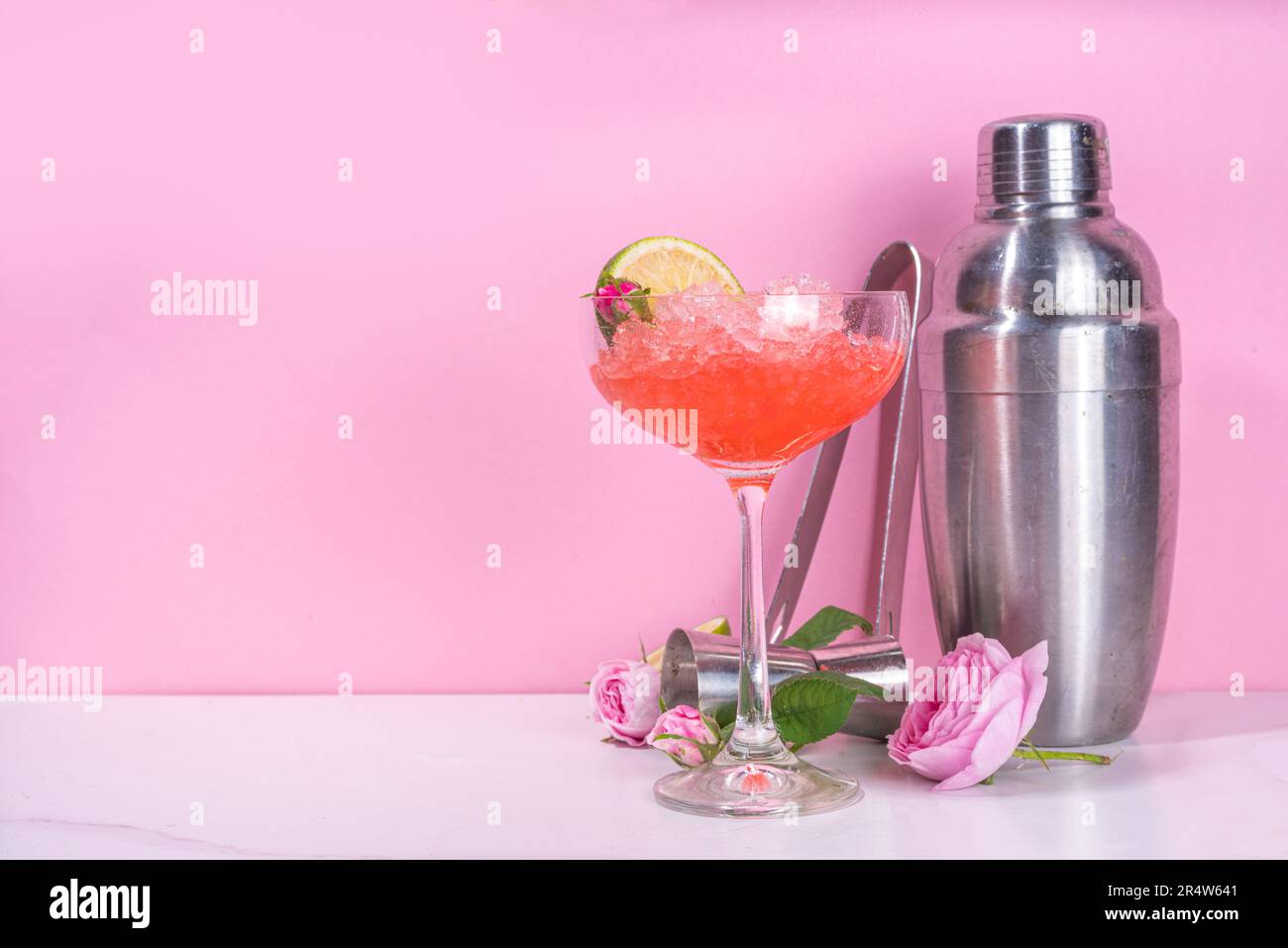 green alcohol drink in glass near half of fresh lime on pink Stock Photo by  LightFieldStudios