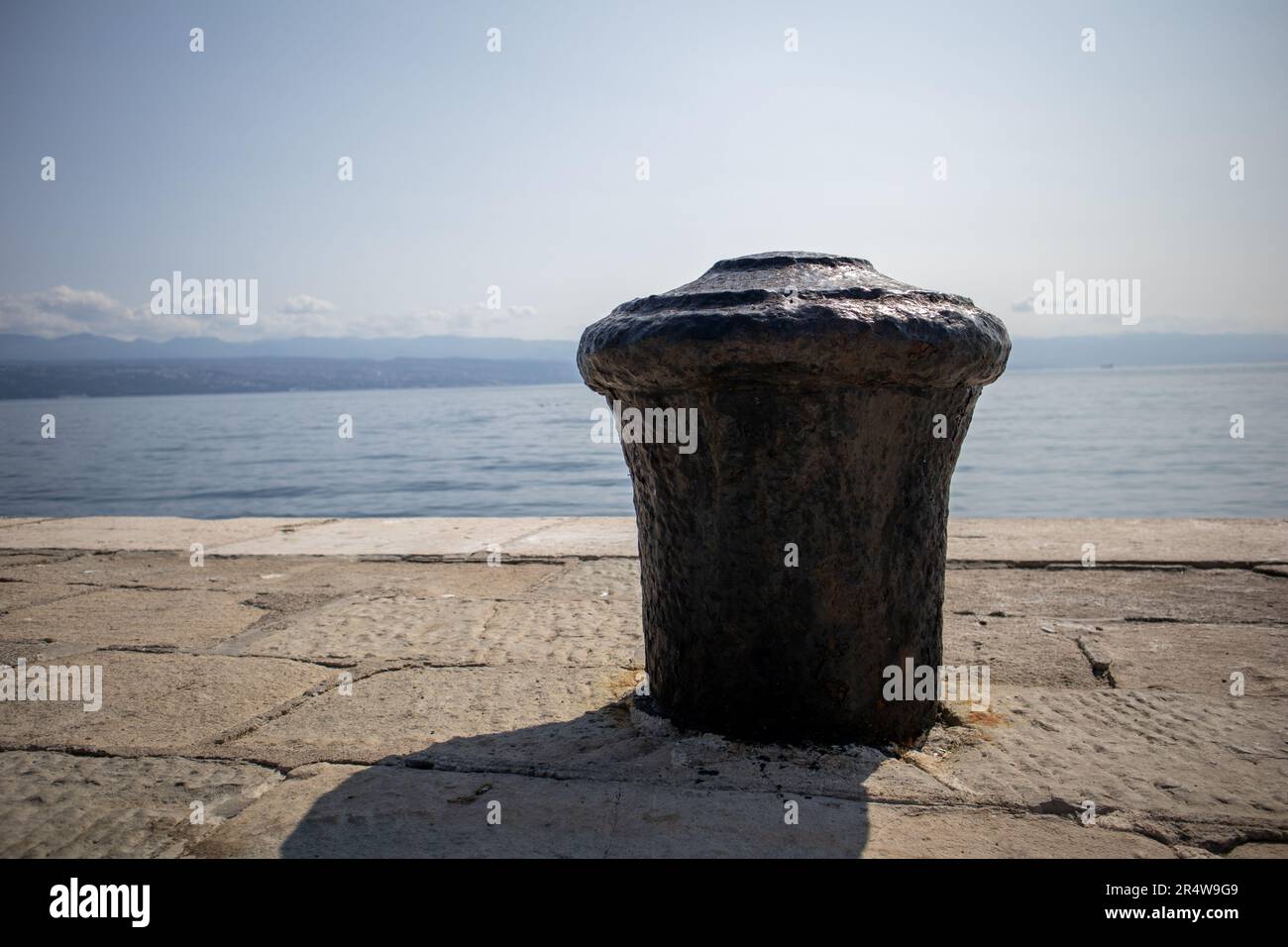 Mooring bitts with blue Adriatic sea and sky Stock Photo