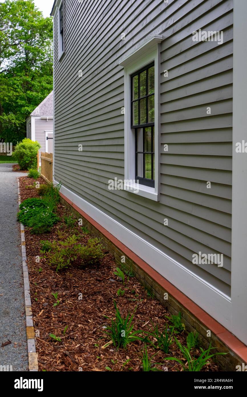 A double hung window with black wood frames, and multiple panes of