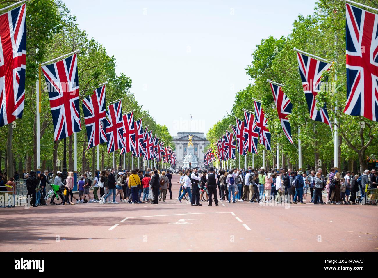 London, UK.  30 May 2023.  People crossing as Union flags line The Mall during a rehearsal for Trooping the Colour.  The Sovereign's birthday is officially celebrated by the ceremony of Trooping the Colour (King's Birthday Parade) and will be the first for King Charles.  A display of military pageantry will take place on 17 June with regiments of the Household Division marching down The Mall to Horse Guards Parade, where the King will attend and take the salute.  Credit: Stephen Chung / Alamy Live News Stock Photo