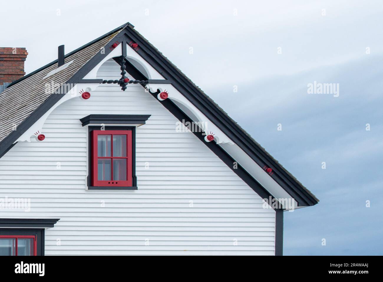 Exterior white wooden wall of horizontal clapboard siding vintage house with black and green