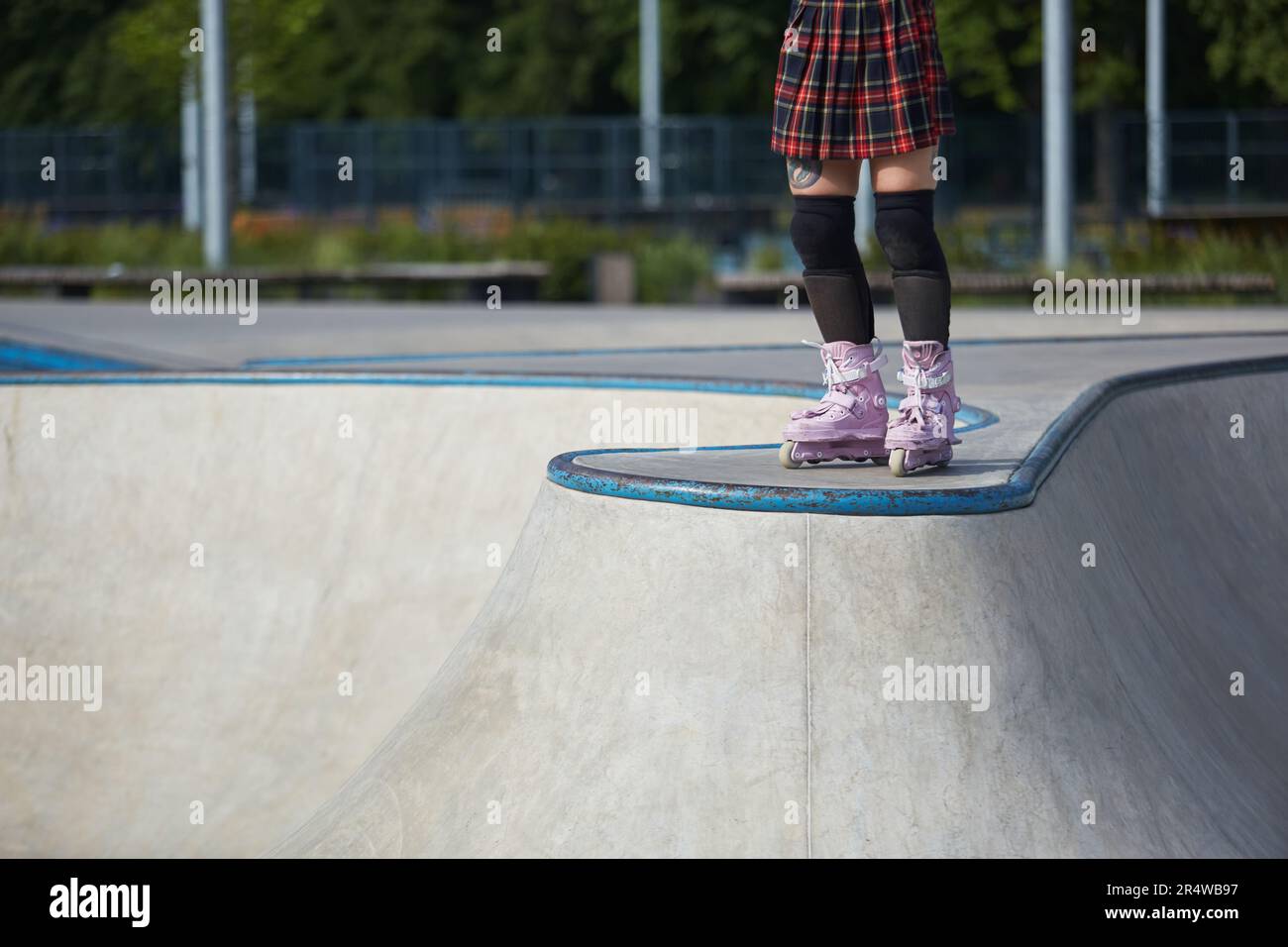 Aggressive inline skater girl wearing modern roller blades and