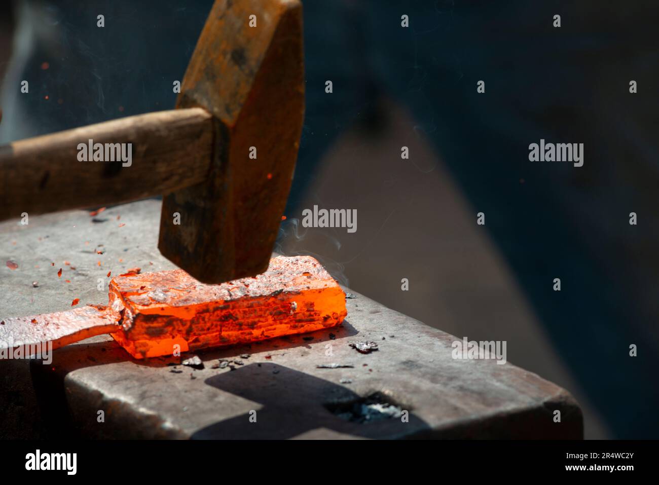 Blacksmith Forging a Red Hot Piece of Iron Stock Photo