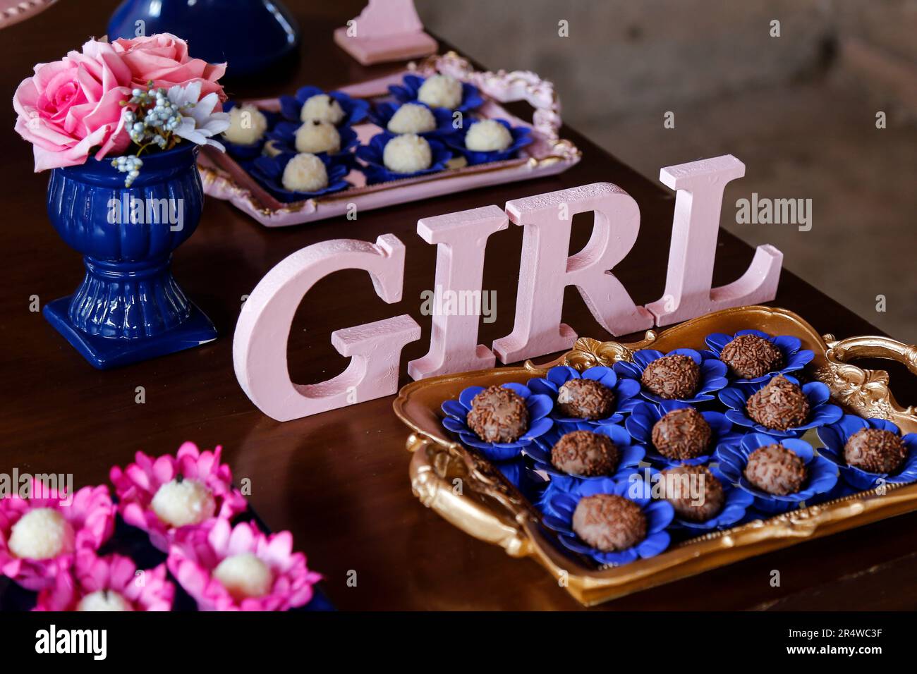 big rose letters GIRL and candy on the table at revelation tea party - baby gender reveal party concept Stock Photo