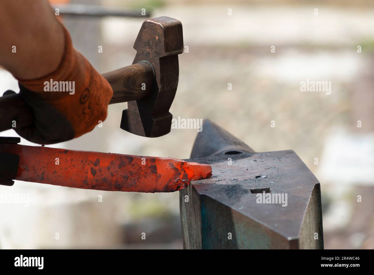 Blacksmith Forging a Red Hot Piece of Iron Stock Photo