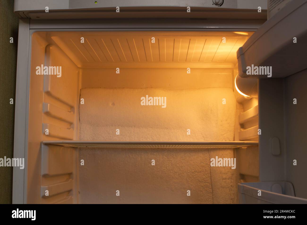 Broken refrigerator with snow inside need repairing. Icing on the back