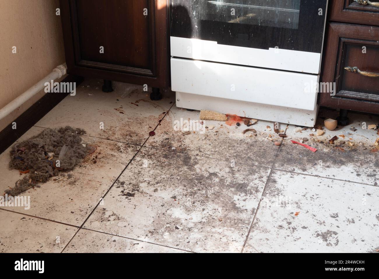 Dirty kitchen floor. Very dirty light tile floor in the kitchen
