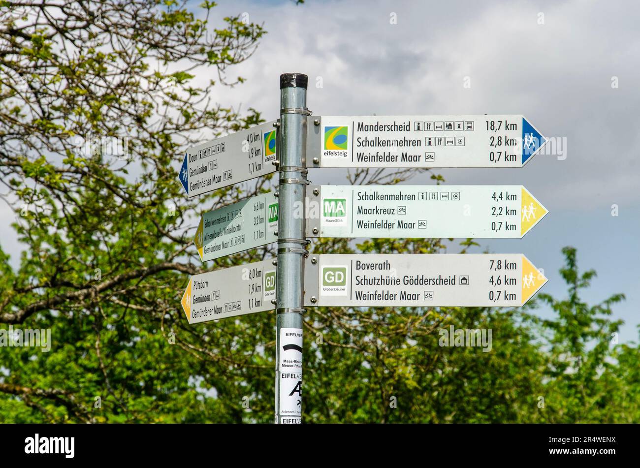 Daun, Germany, May 26, 2023: pole with signs indicating hiking trail around the Maare crater lakes Stock Photo