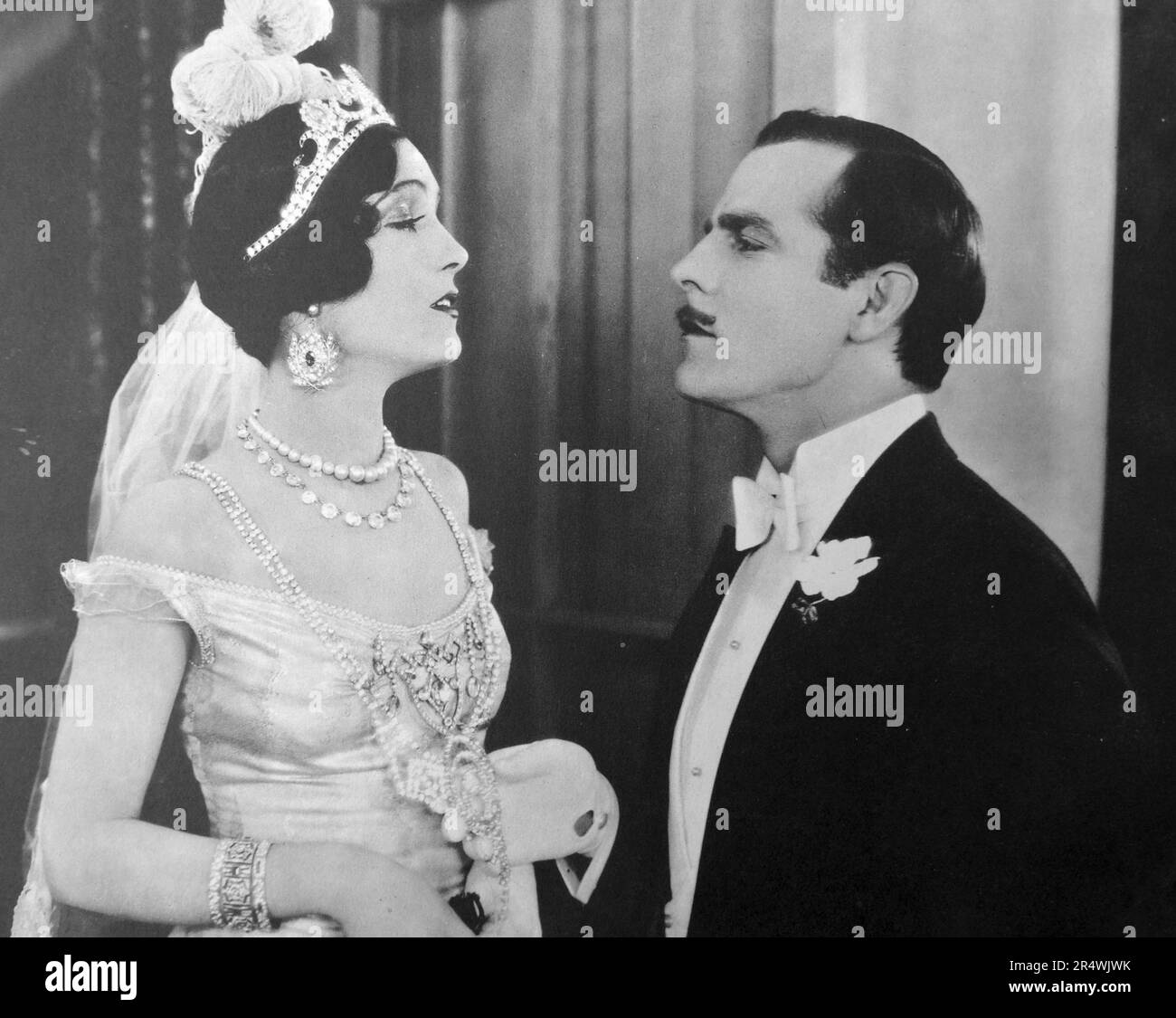Hauteur at its height.  The studio caption says 'Lord St. Austel (Antonio Moreno) tells his bride (Pauline Starke) that she has discredited the family name, in a scene from Love's Blindness, 1926, an Elinor Glyn production for Metro-Goldwyn-Mayer. Stock Photo
