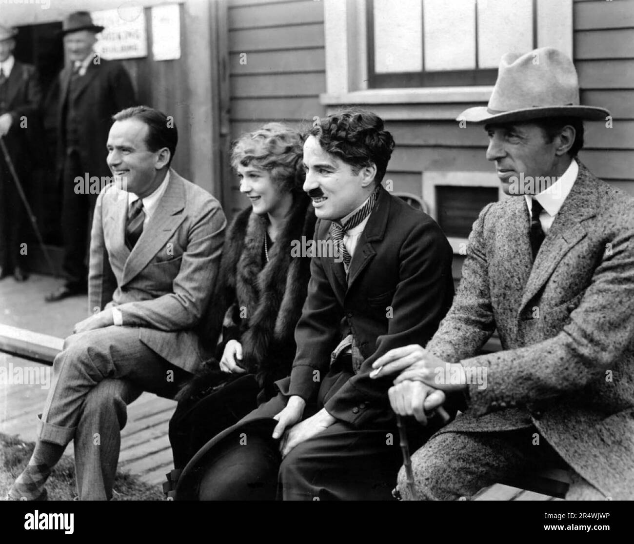 Photograph of the United Artist Corporation film studio members: D. W. Griffith, Charlie Chaplin, Mary Pickford and Douglas Fairbanks. Dated 1919 Stock Photo