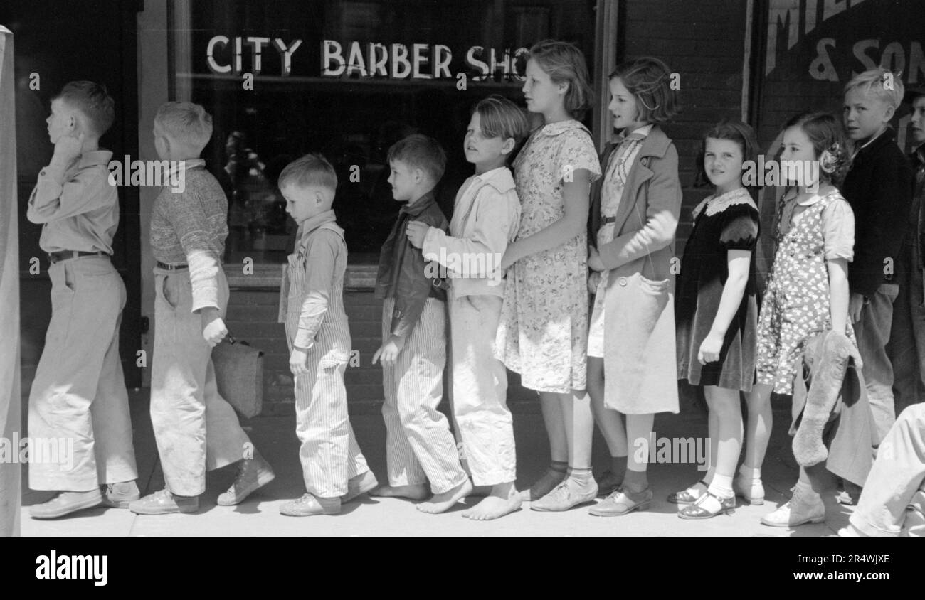 Schoolchildren waiting in line to go to the movies, San Augustine, Texas. Stock Photo