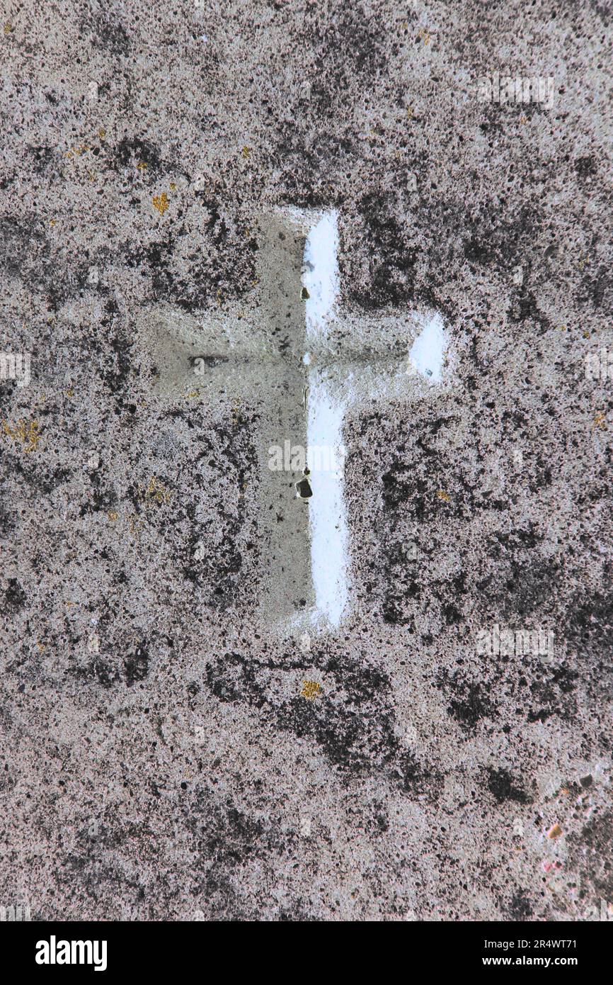 A simple cross carved into a vintage natural stone wall Stock Photo - Alamy