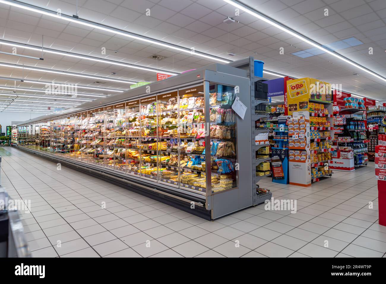 Italy - May 25, 2023: large refrigerated counter with fresh products such as pasta and cheese inside Italian supermarket Stock Photo
