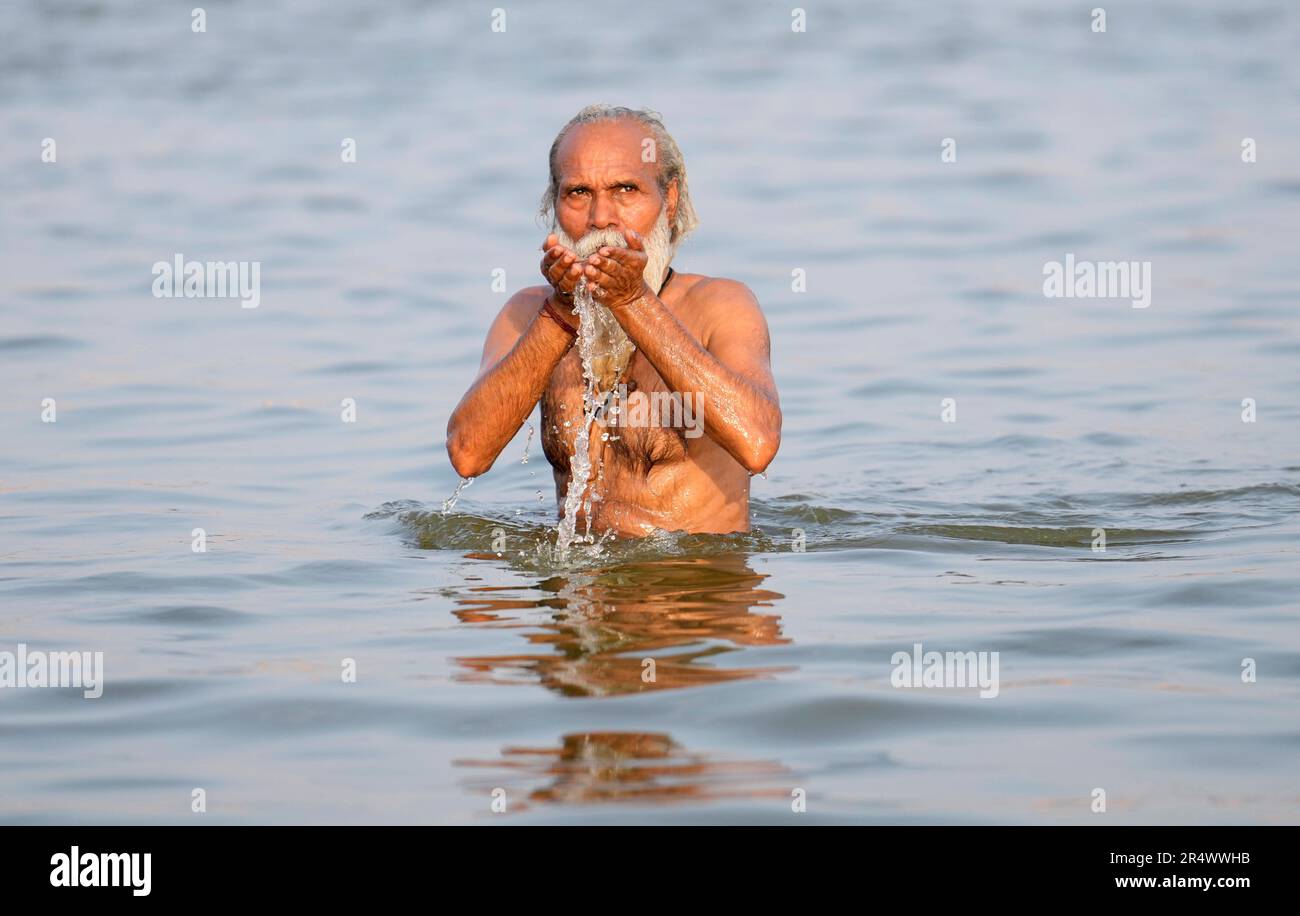 A Hindu holy man offers prayers in the River Ganges on Ganga Dussehra festival in Prayagraj, India, Tuesday, May 30, 2023. Hindus across the country celebrate Ganga Dussehra by worshiping the River Ganges, which is considered as the most sacred and the holiest river. (AP Photo/Rajesh Kumar Singh) Stock Photo