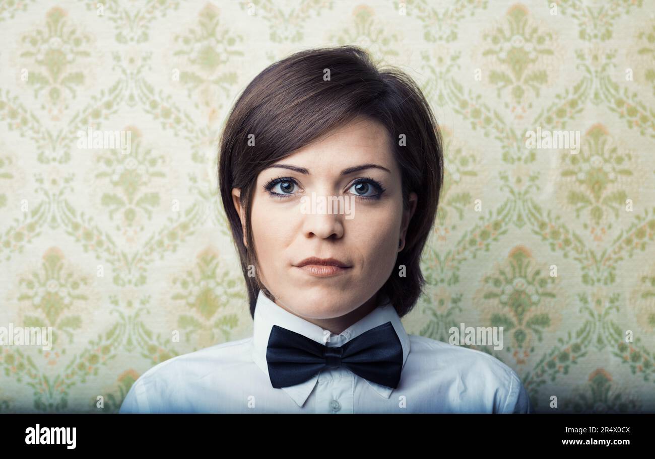 Young woman with boyish hair, sharp frontal portrait. Vintage wallpaper