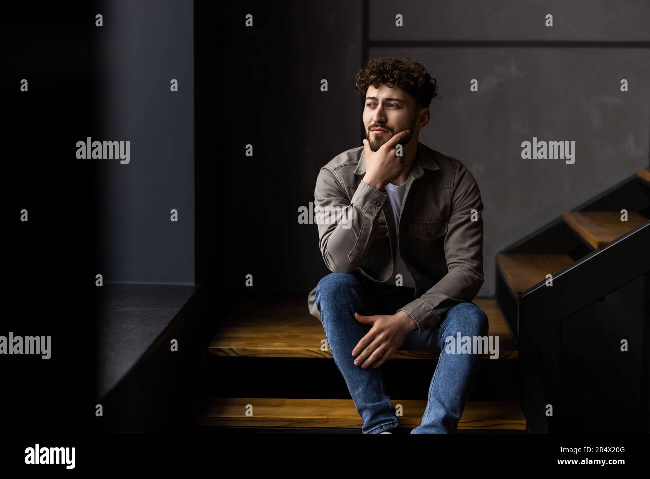 Depressed sulking man sitting hi-res stock photography and images - Alamy