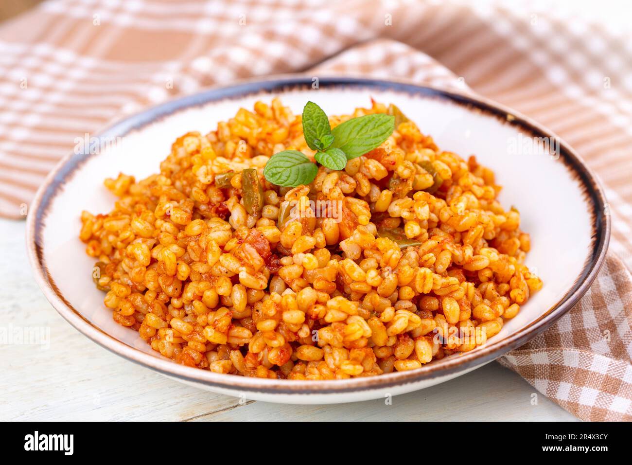 Traditional turkish bulgur pilaf with tomato sause in plate (Turkish ...