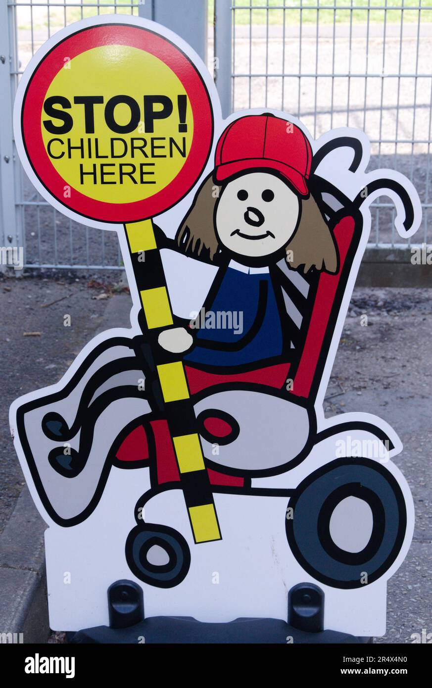Image of a child with a 'stop! children here' message outside a school in Manchester, UK, safety, advice to drivers, driving safely Stock Photo