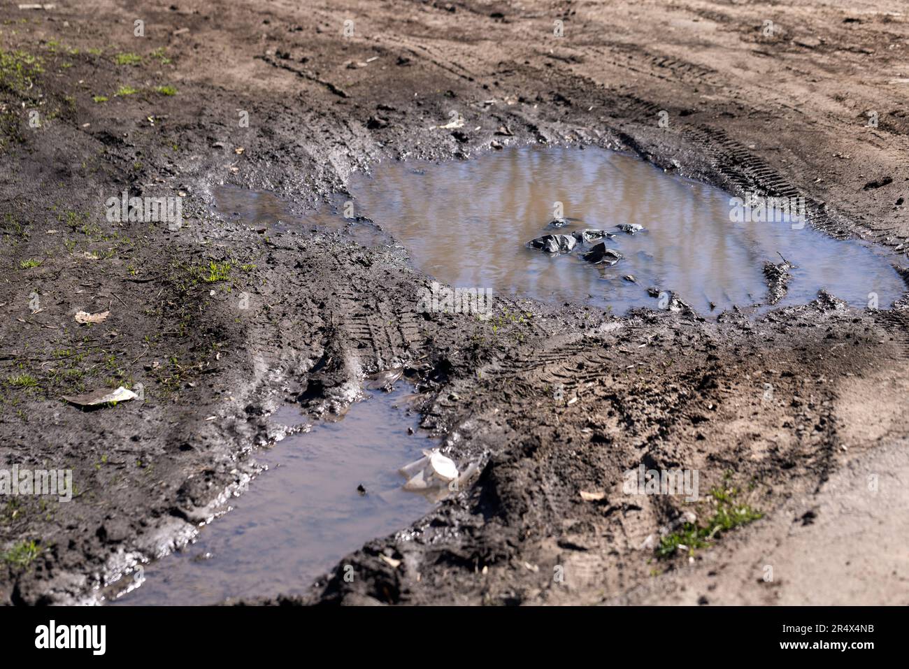 Dirty country road with large puddles after rain. Dirt road after heavy ...