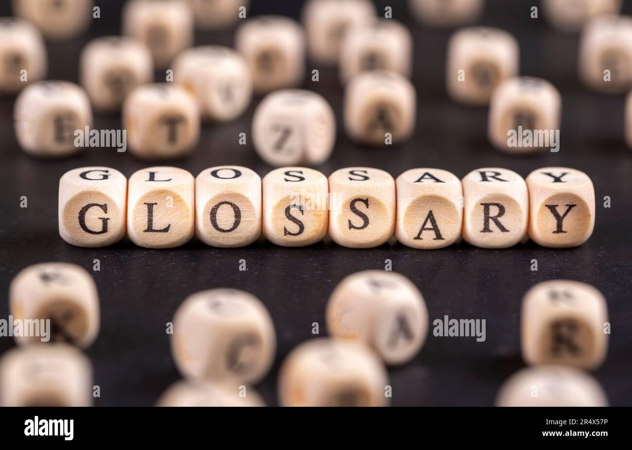 Glossary word from wooden blocks with letters, alphabetical list with