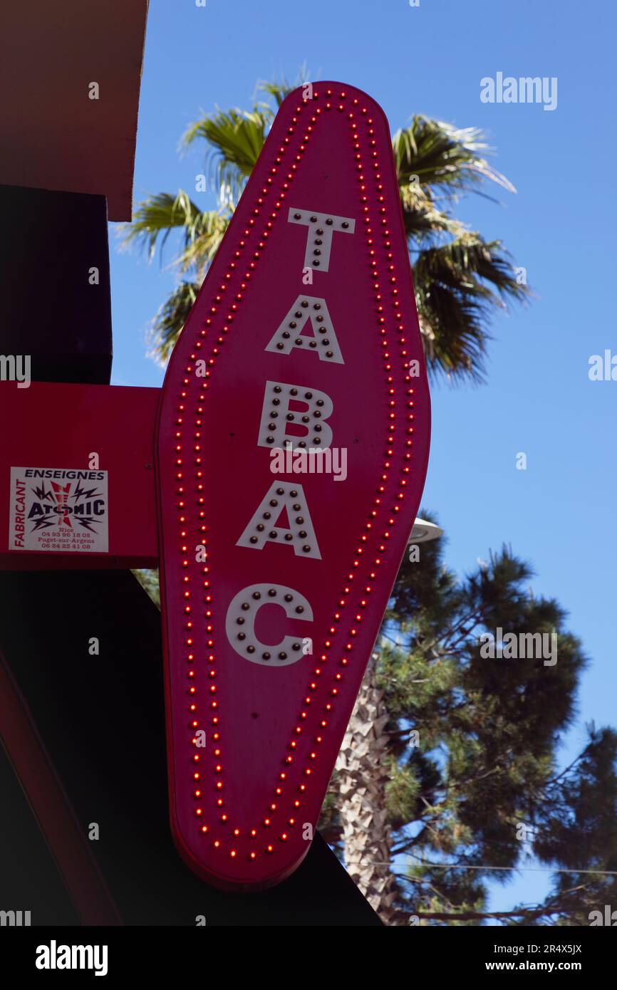 France, Provence-Alps, Cote d'Azur, Antibes Juan-les-Pins, Red illuminated Tabac sign. Stock Photo