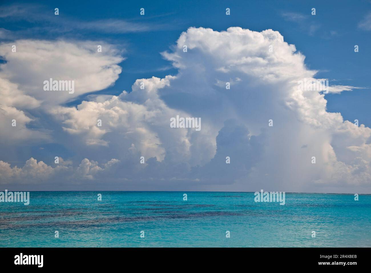 Turquoise blue water in the Seychelles Islands with cloud formations in the sky; Seychelles Stock Photo