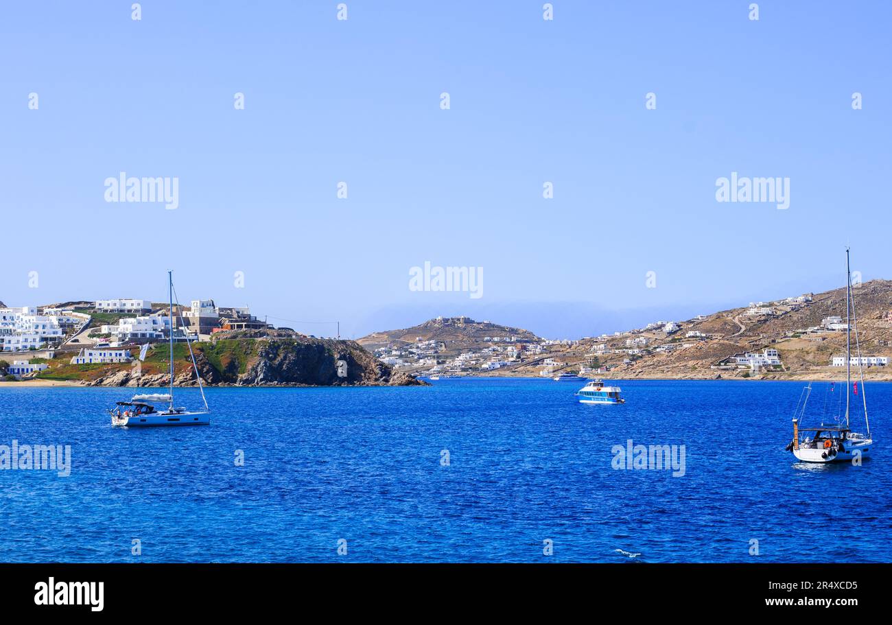 Scenic view overlooking a small bay on the Greek Island of Mykonos, with turquoise sea and hilly backdrop Stock Photo
