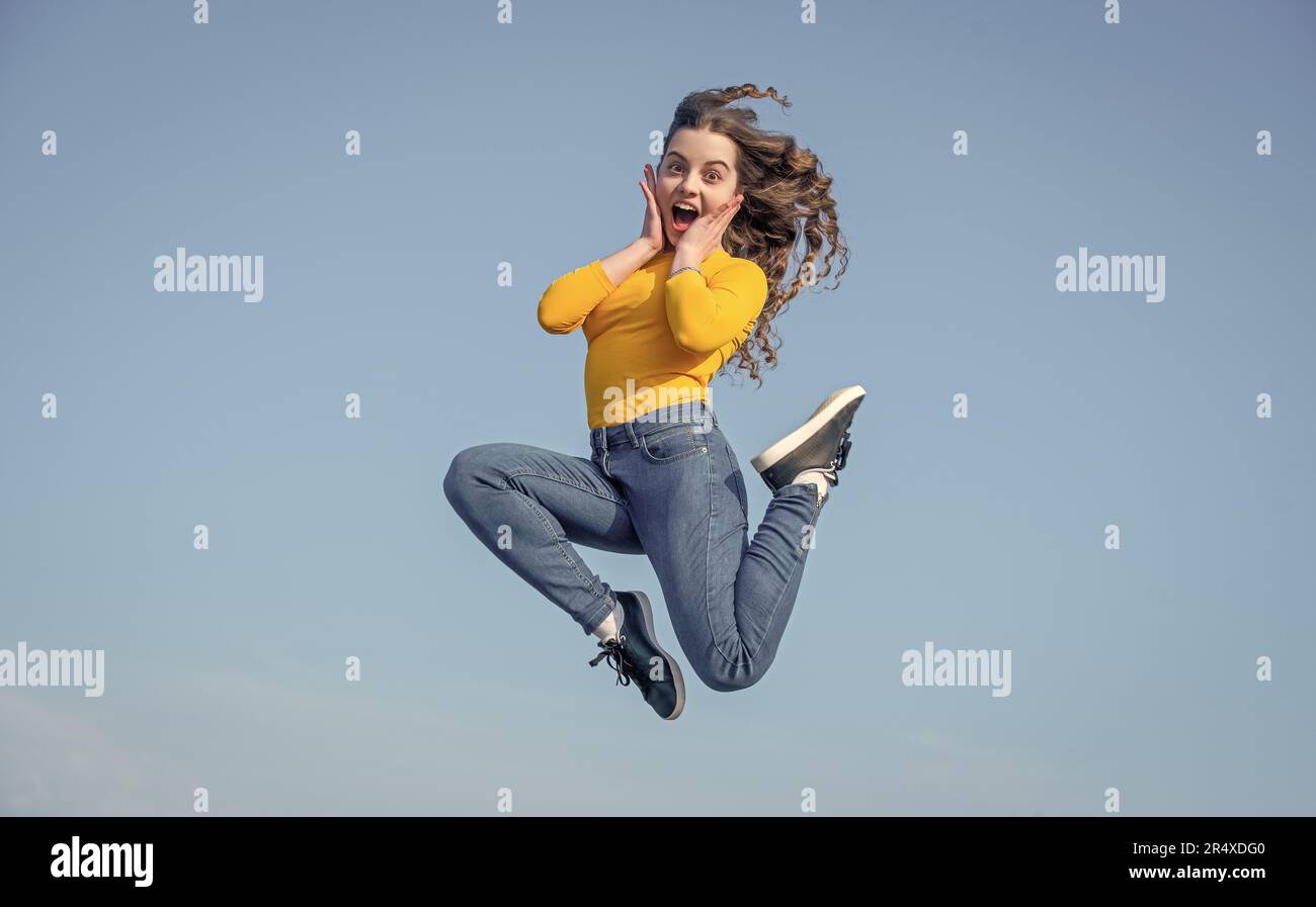 amazed teen girl jump high on sky background Stock Photo - Alamy