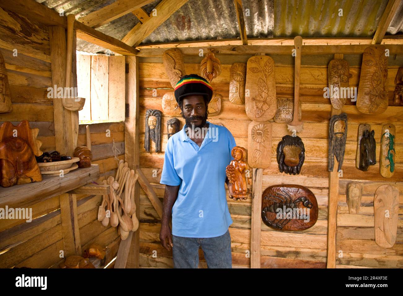 Wood carver stands inside his studio in Jamaica; Bluefields Bay, Jamaica Stock Photo