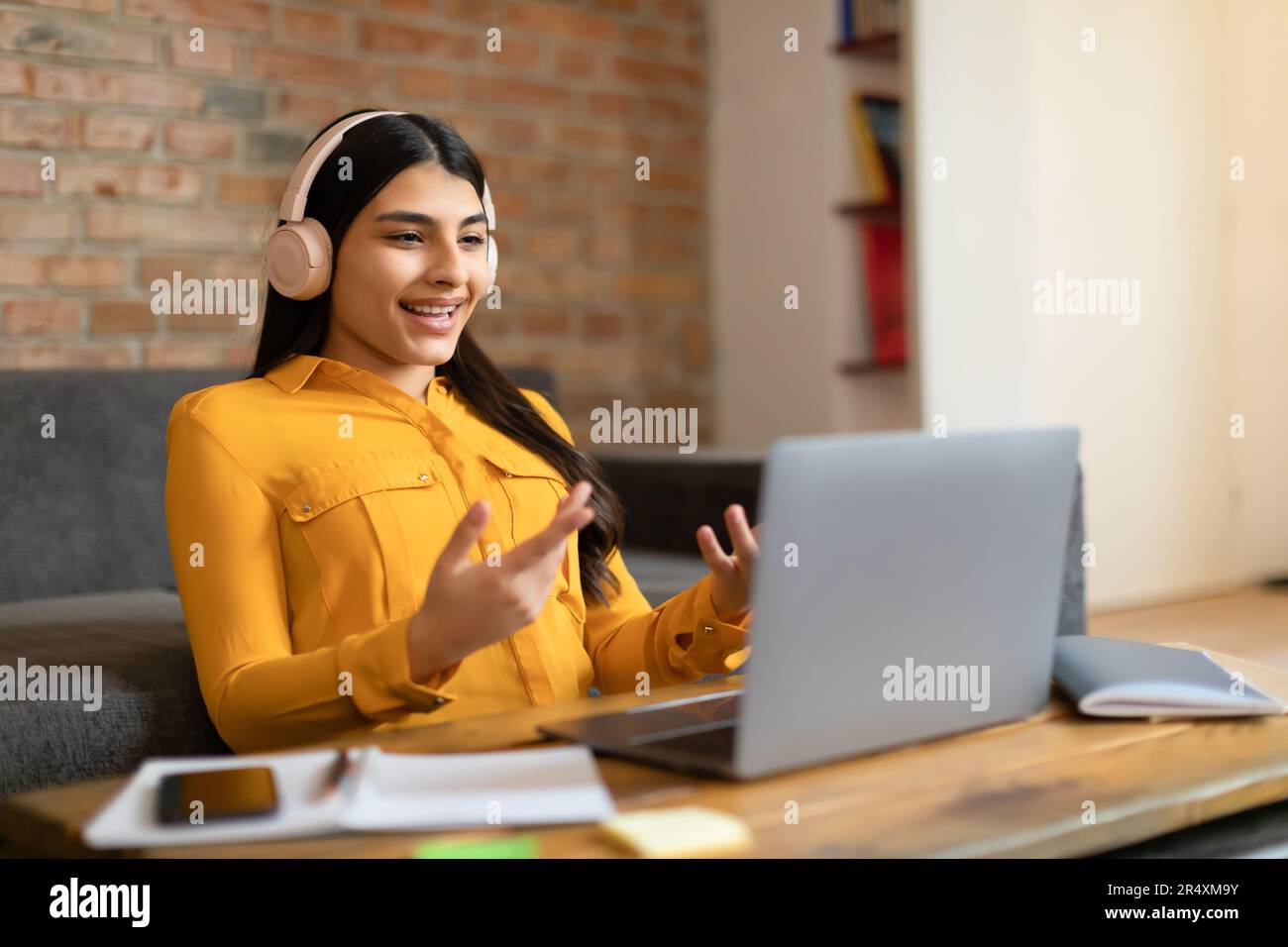 Power of elearning. Spanish lady student in headphones making video