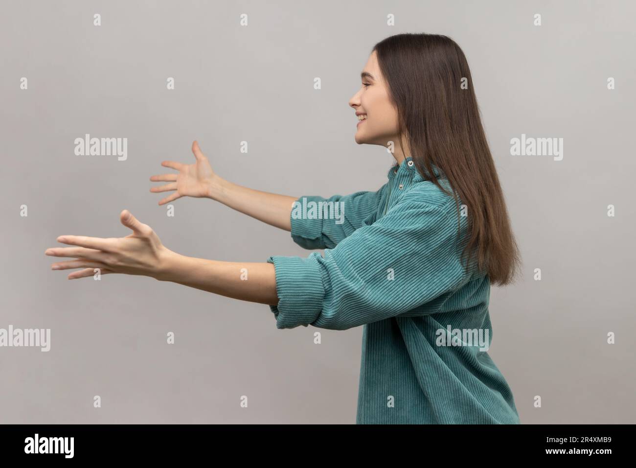 Come into my arms, free hugs. Side view of adorable hospitable woman