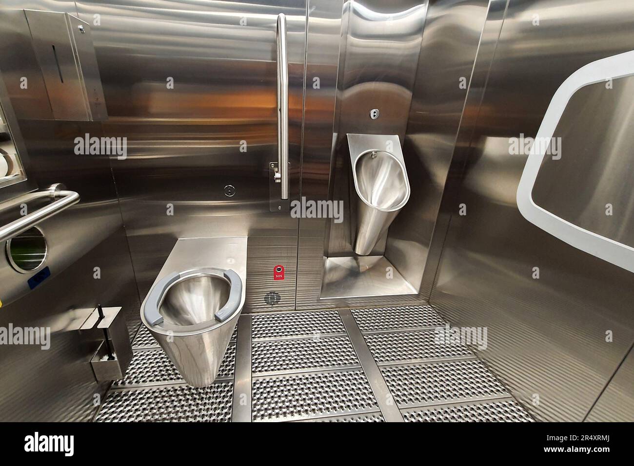 Sanitary metal urinal and toilet bowl in public bathroom with hygienic