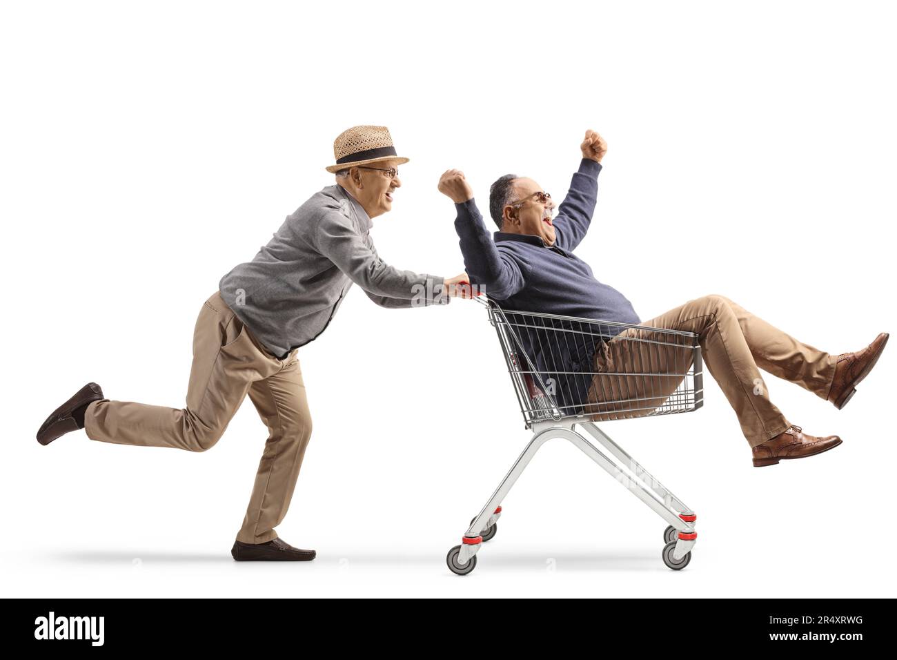 Senior man riding a man inside a shopping cart isolated on white