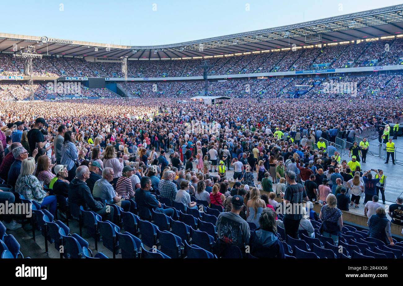 Music fans watch Bruce Springsteen, with the E Street Band, on stage at Murrayfield, Edinburgh